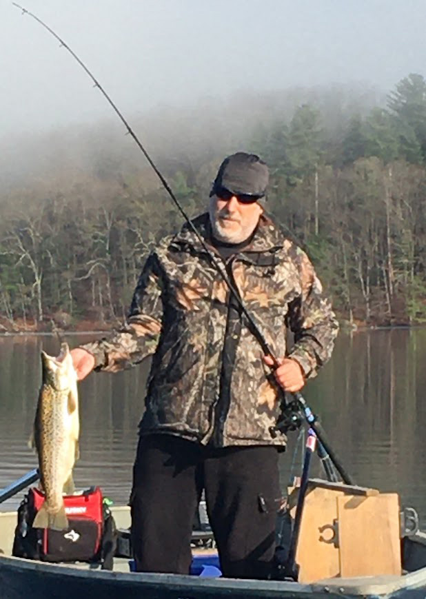 Photo of a fisherman holding a brown trout